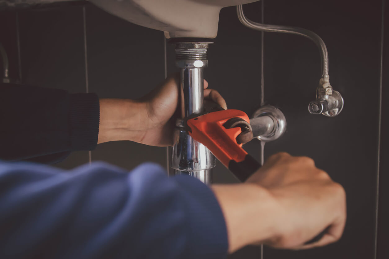 Plumber at work in a bathroom, plumbing repair service , fix water plumbing leaks